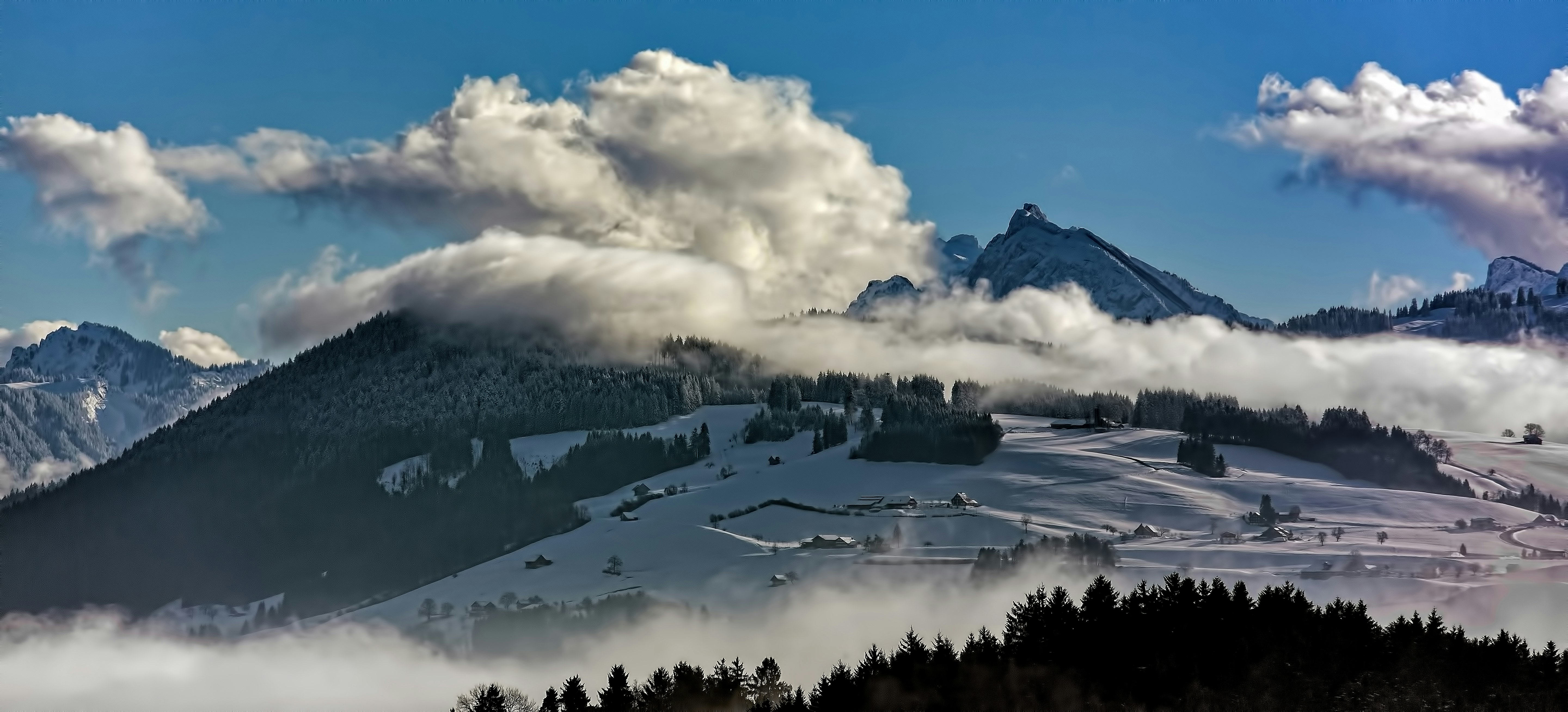 mountain covered by white clouds